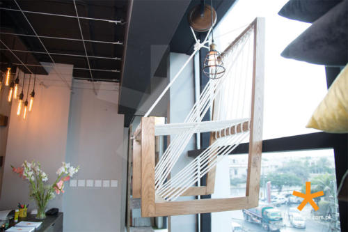 chair-hung-to-the-display-window-with-pulley